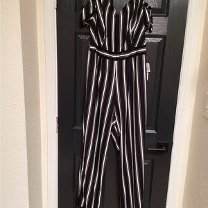 Teeze Me Black and White Striped Jumpsuit, pit to pit 20”, inseam 28”. 326